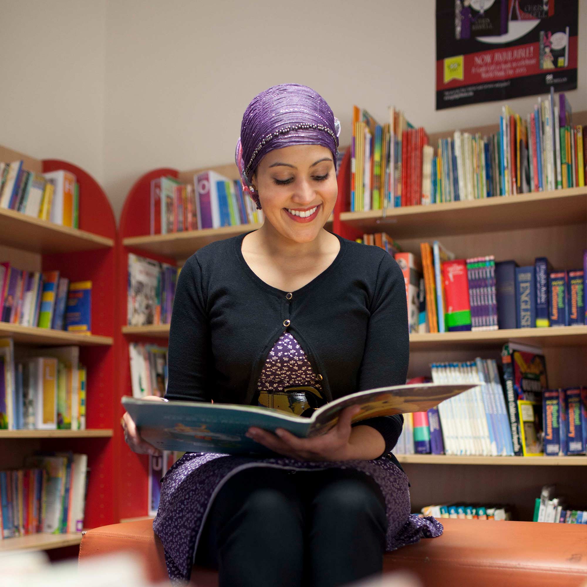 Student reading childrens books in a classroom