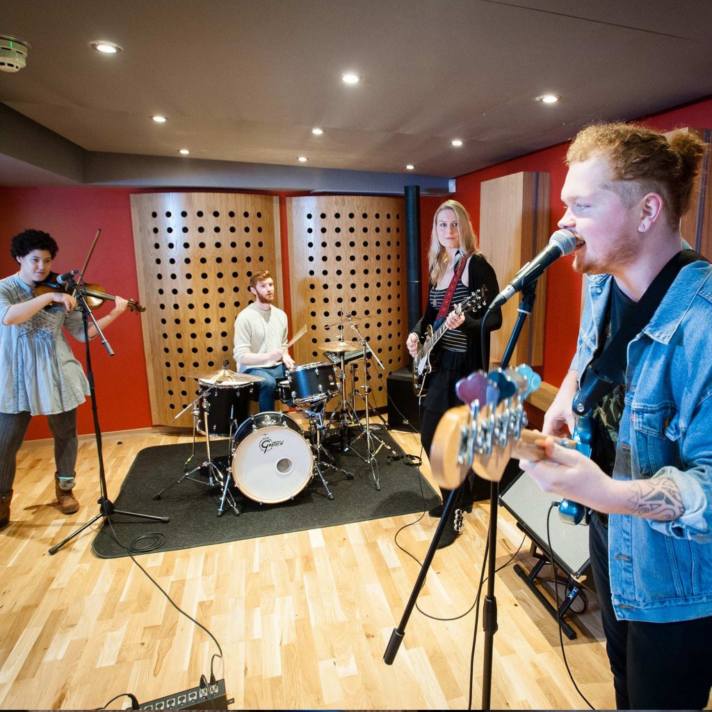 Student band recording in a studio