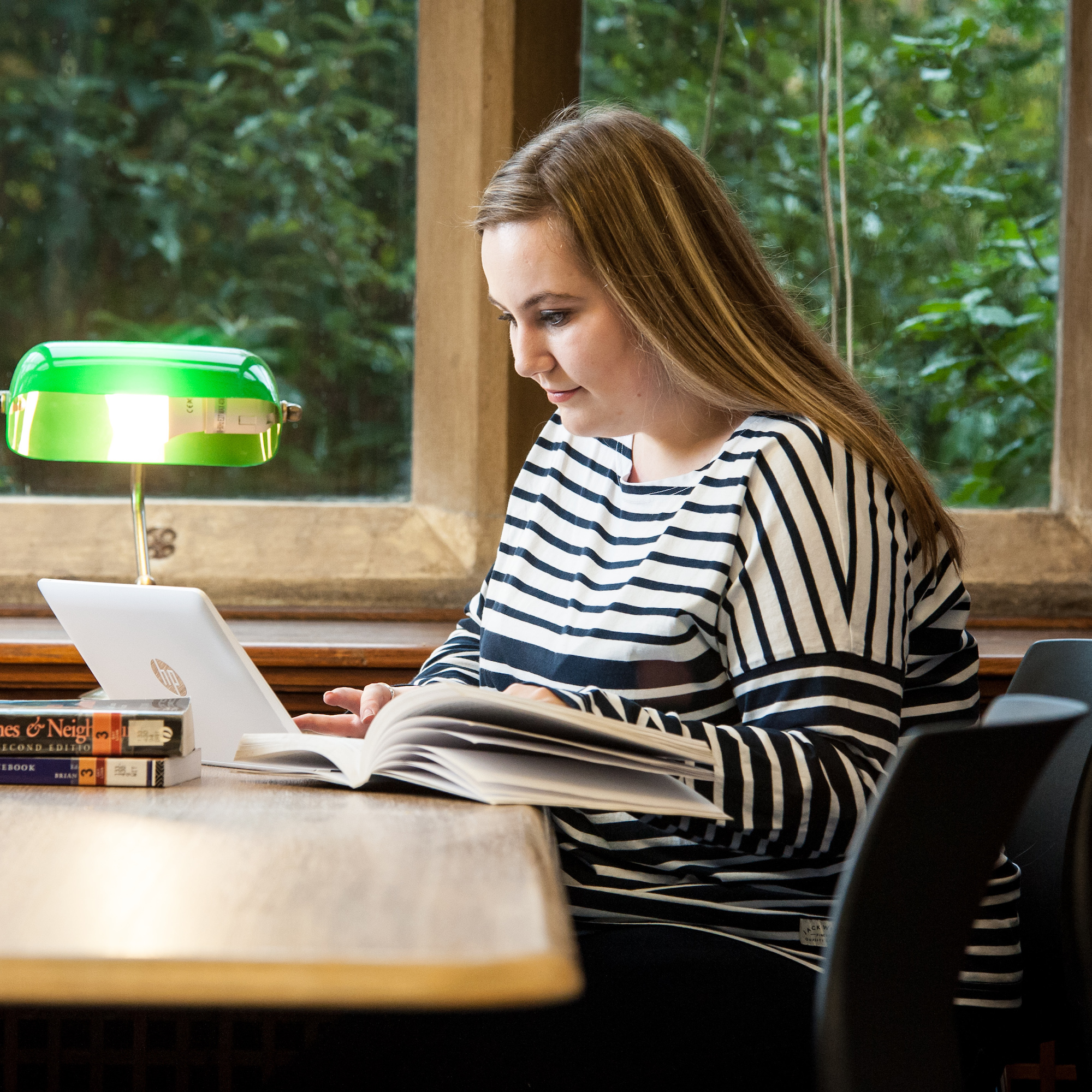 A girl sits at a desk studying