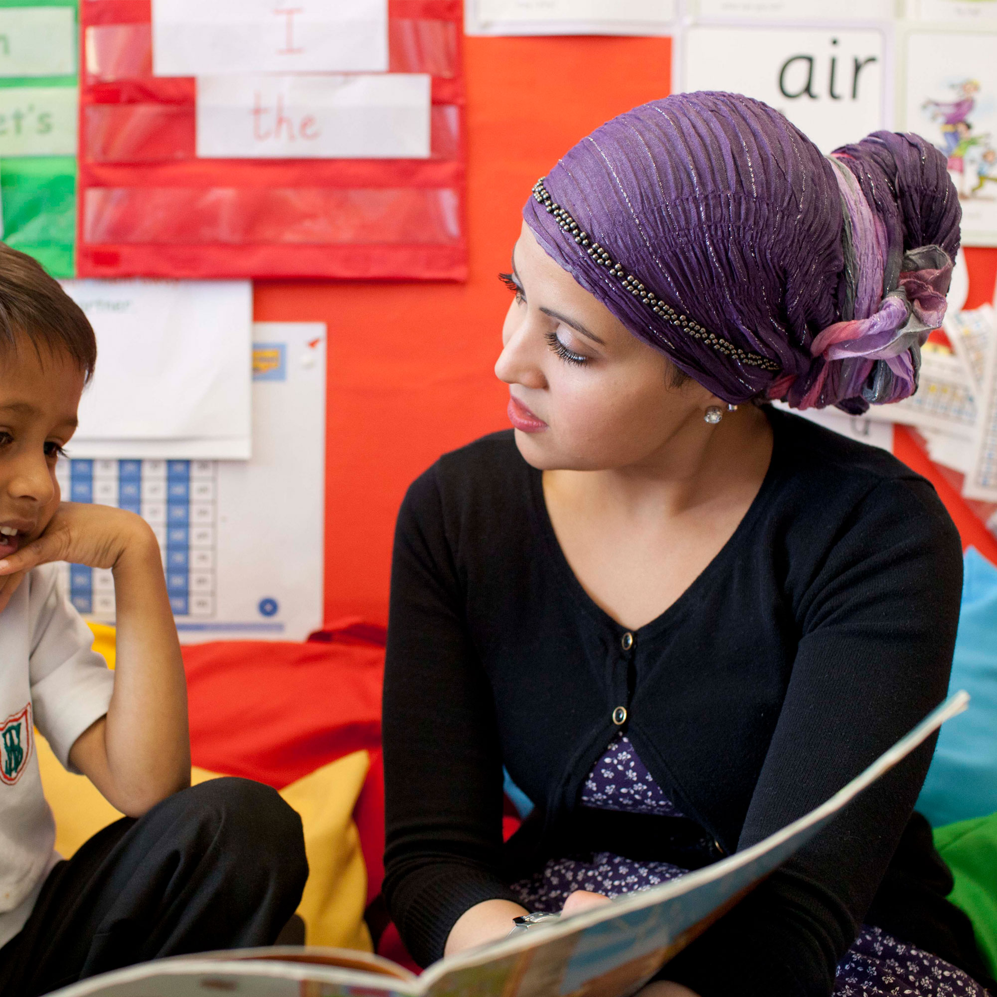 Student teacher on placement teaching primary school child