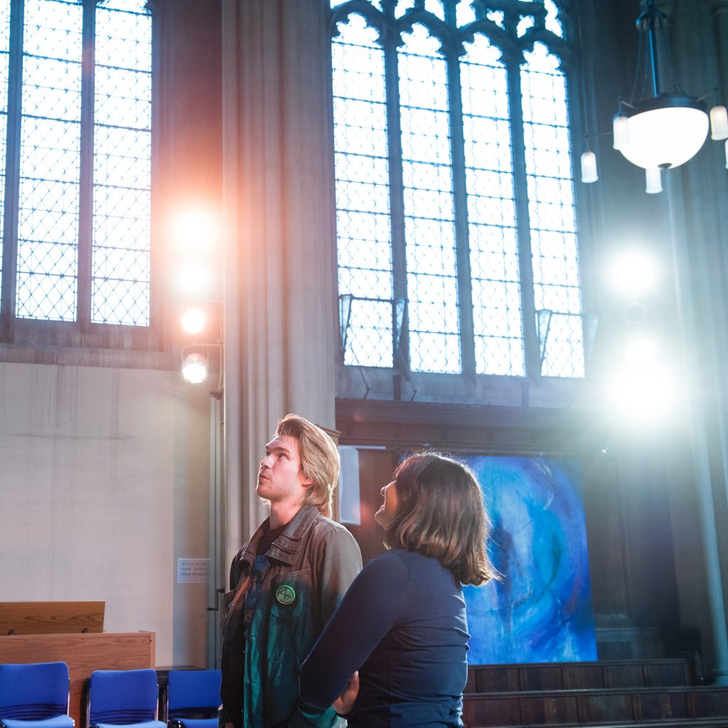 A student and a teacher standing together in a church