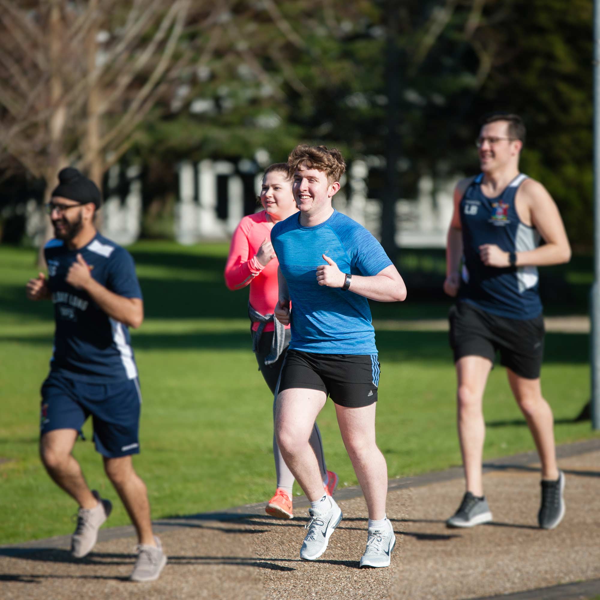 Students jogging around park campus