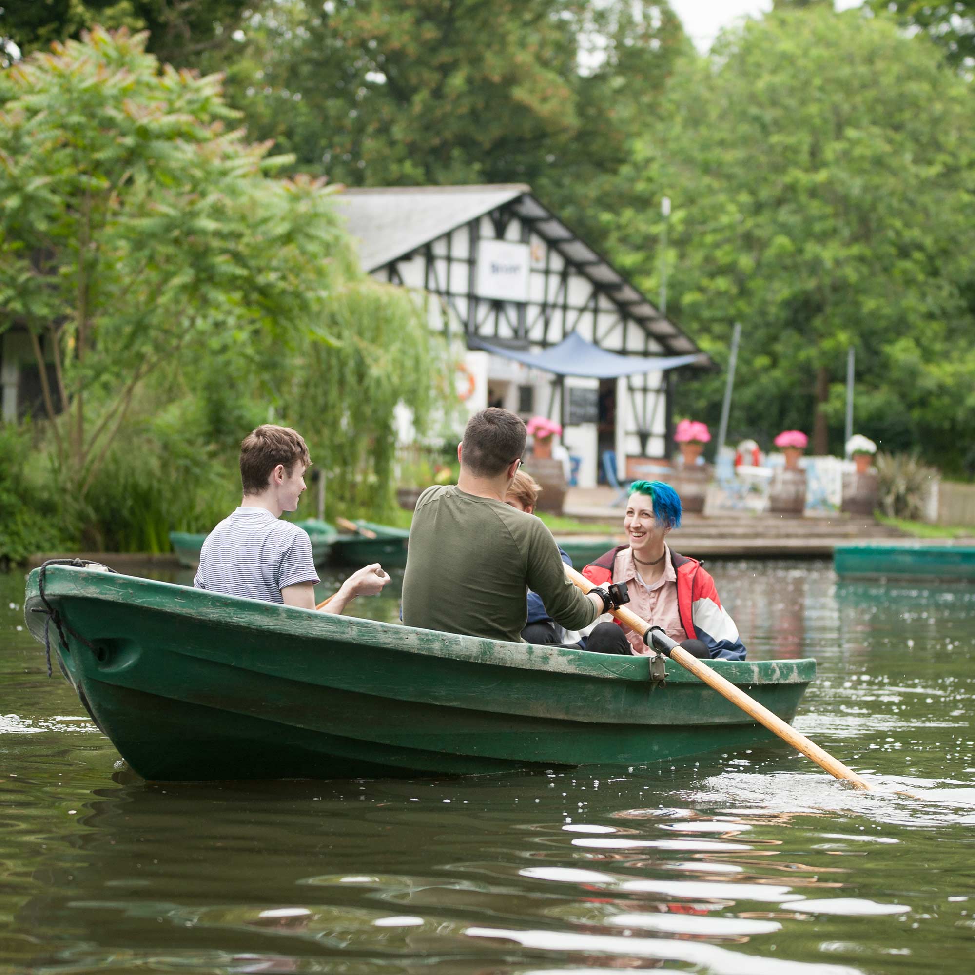 Students in a rowing boat on a lake