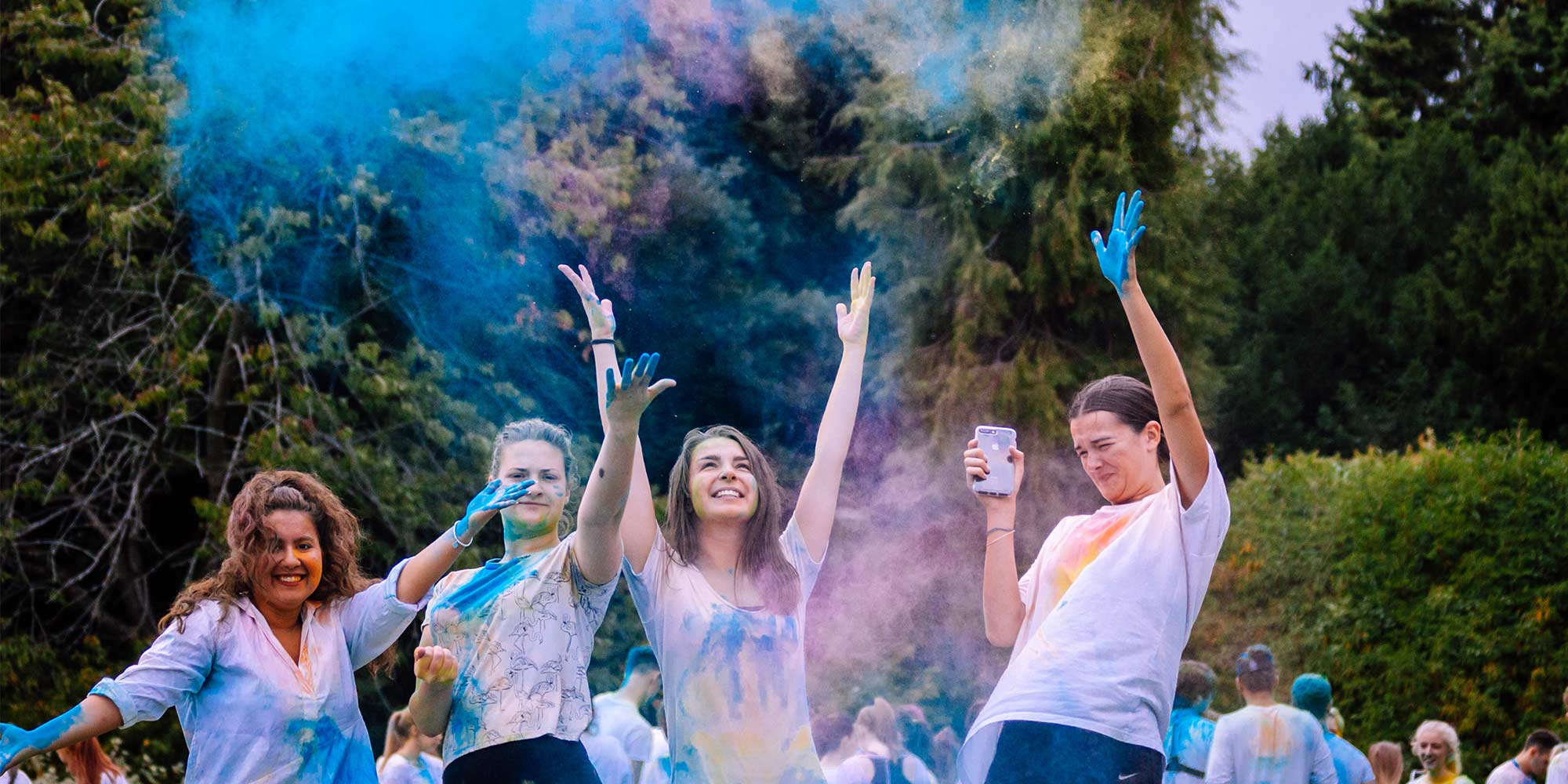 Students throwing coloured paint on eachother
