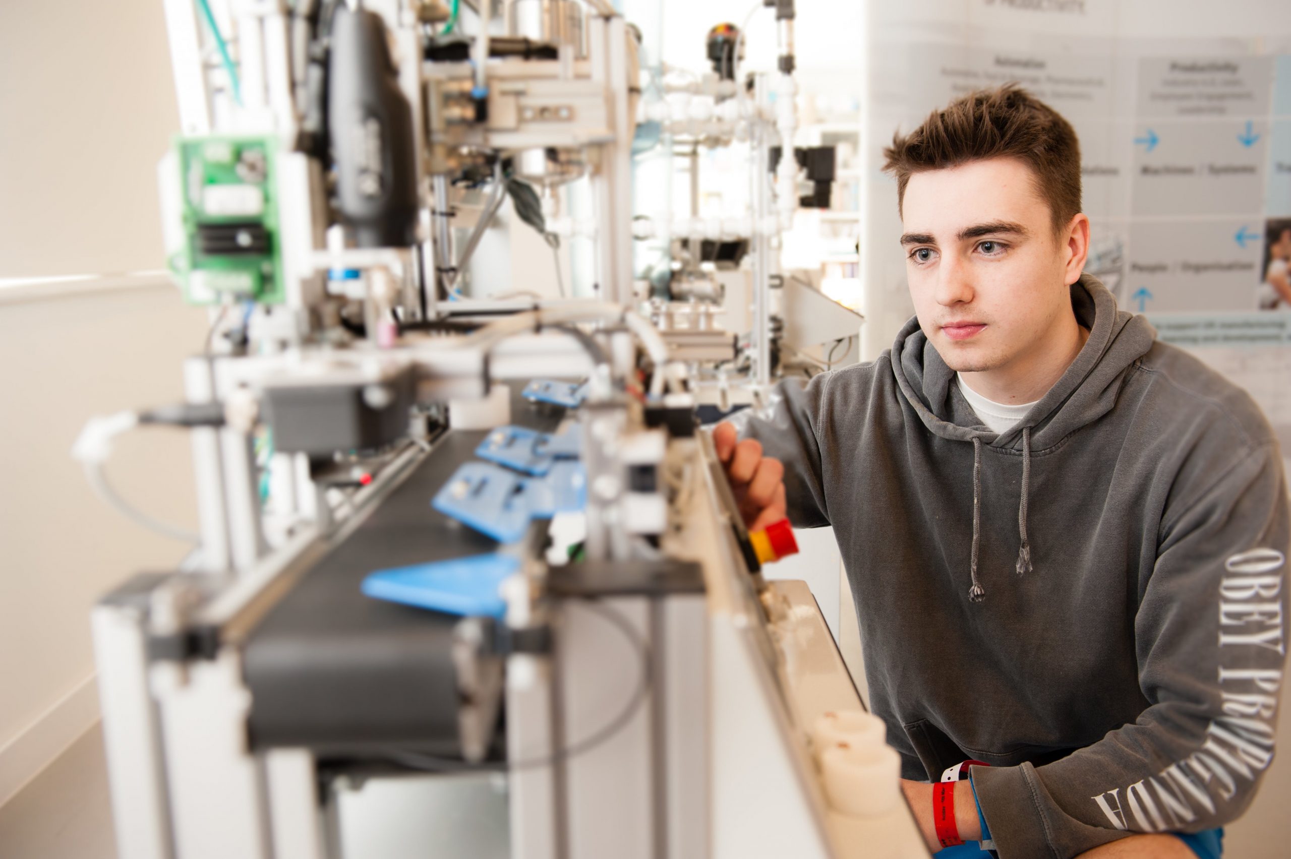 student examining engineering equipment