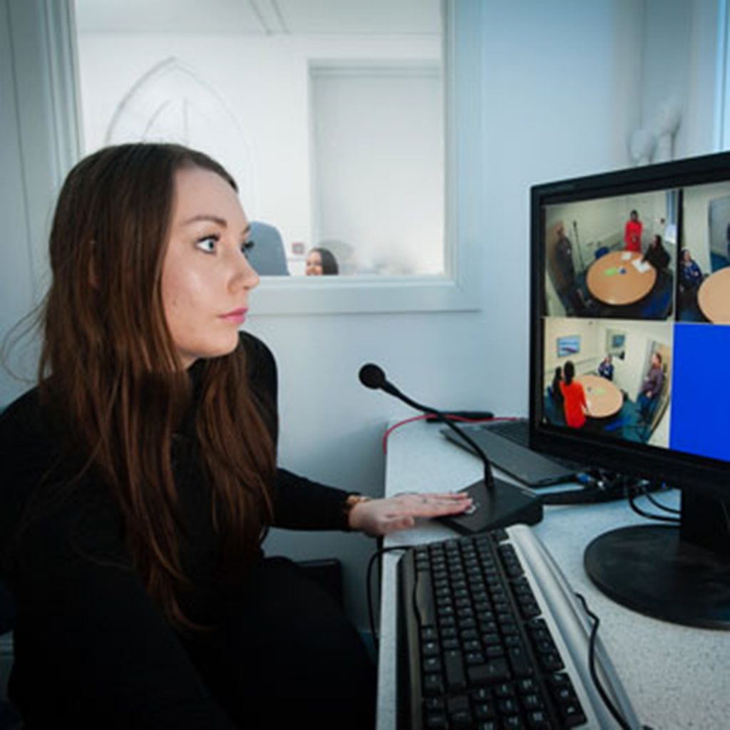 woman watching an interview take place