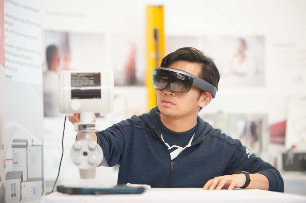 a student examining engineering equipment
