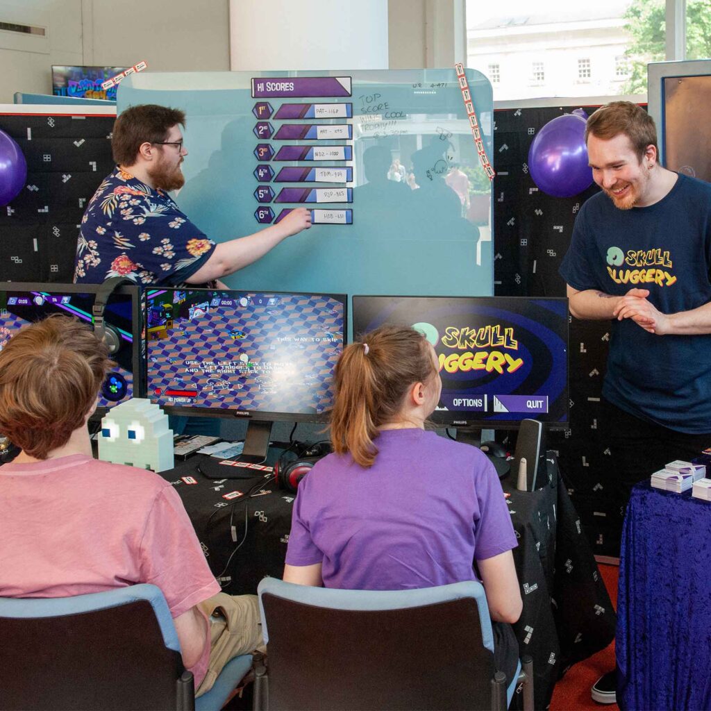 Students playing an exhibited game at COMX