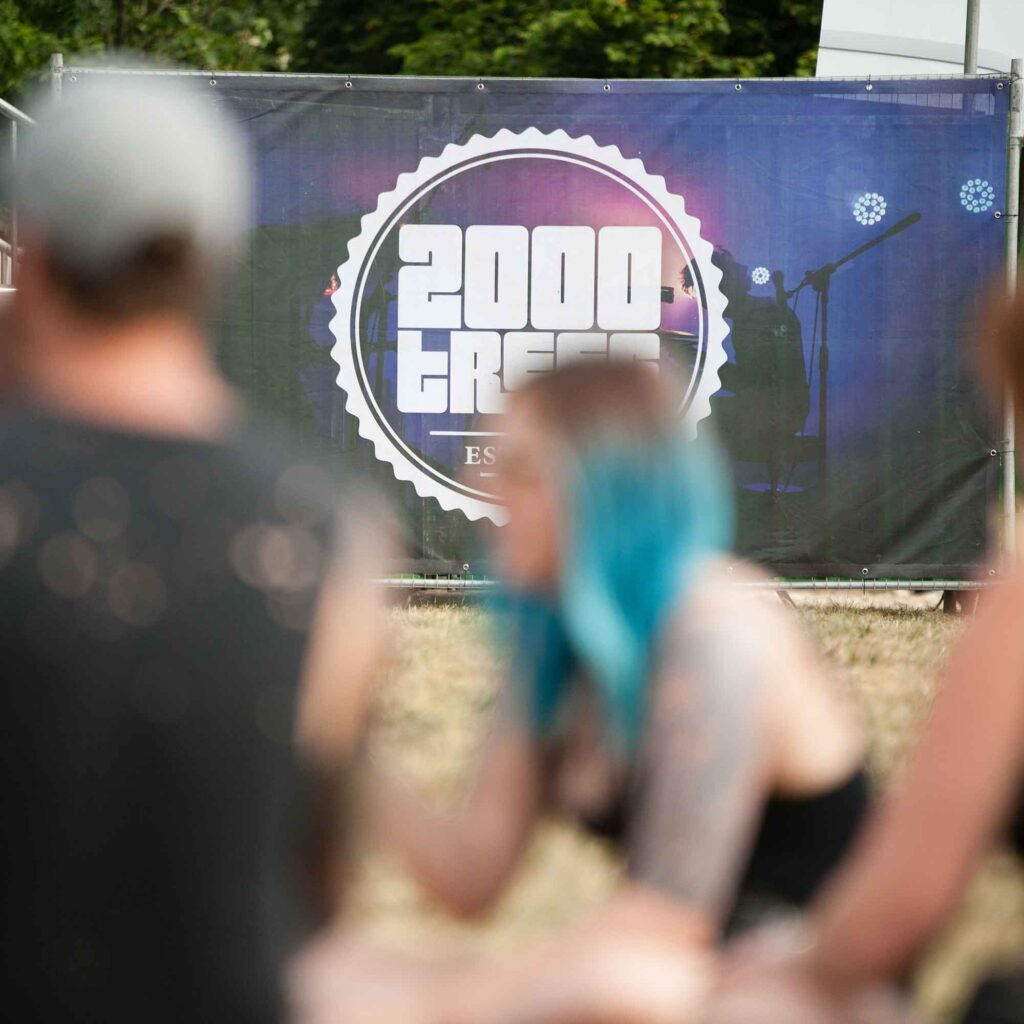 2000 trees festival sign with attendees in the foreground