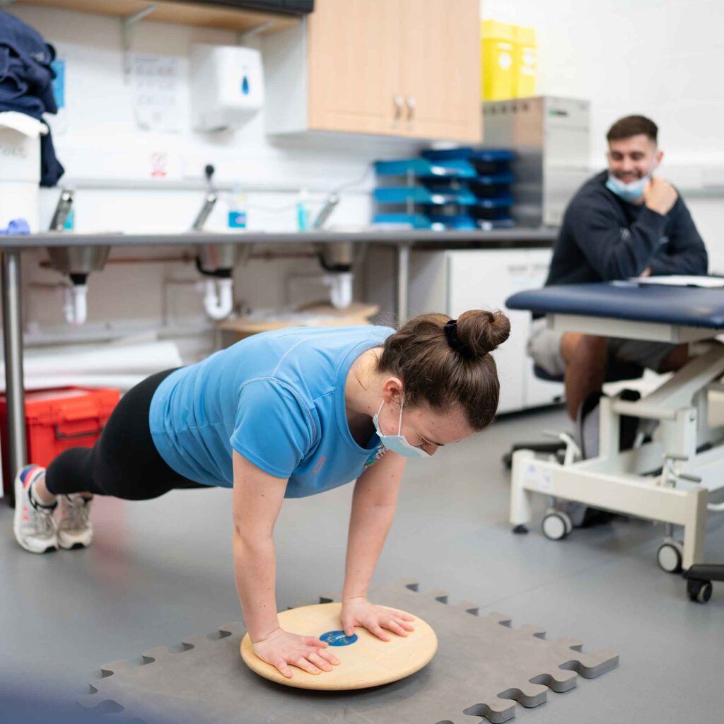 Students in sports therapy room undertaking exercises