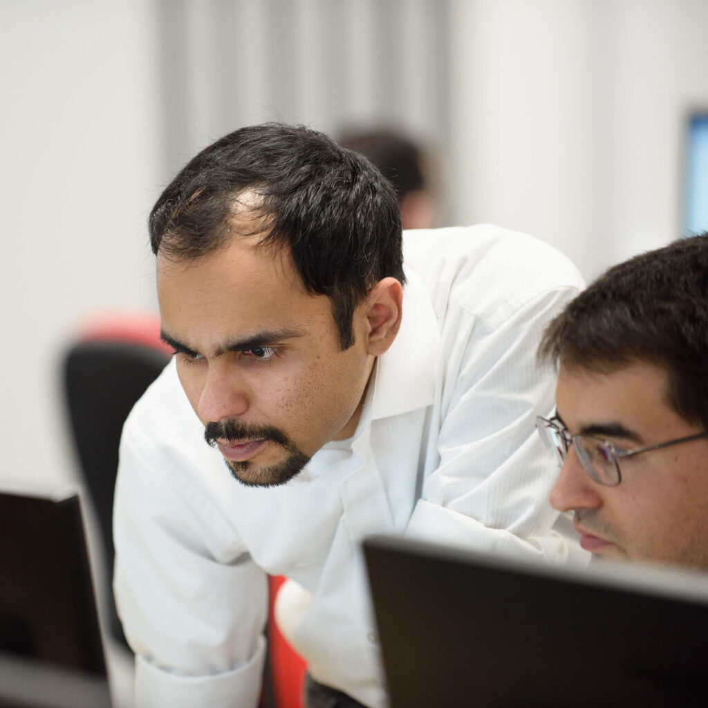 Lecturer supporting cyber student on computer
