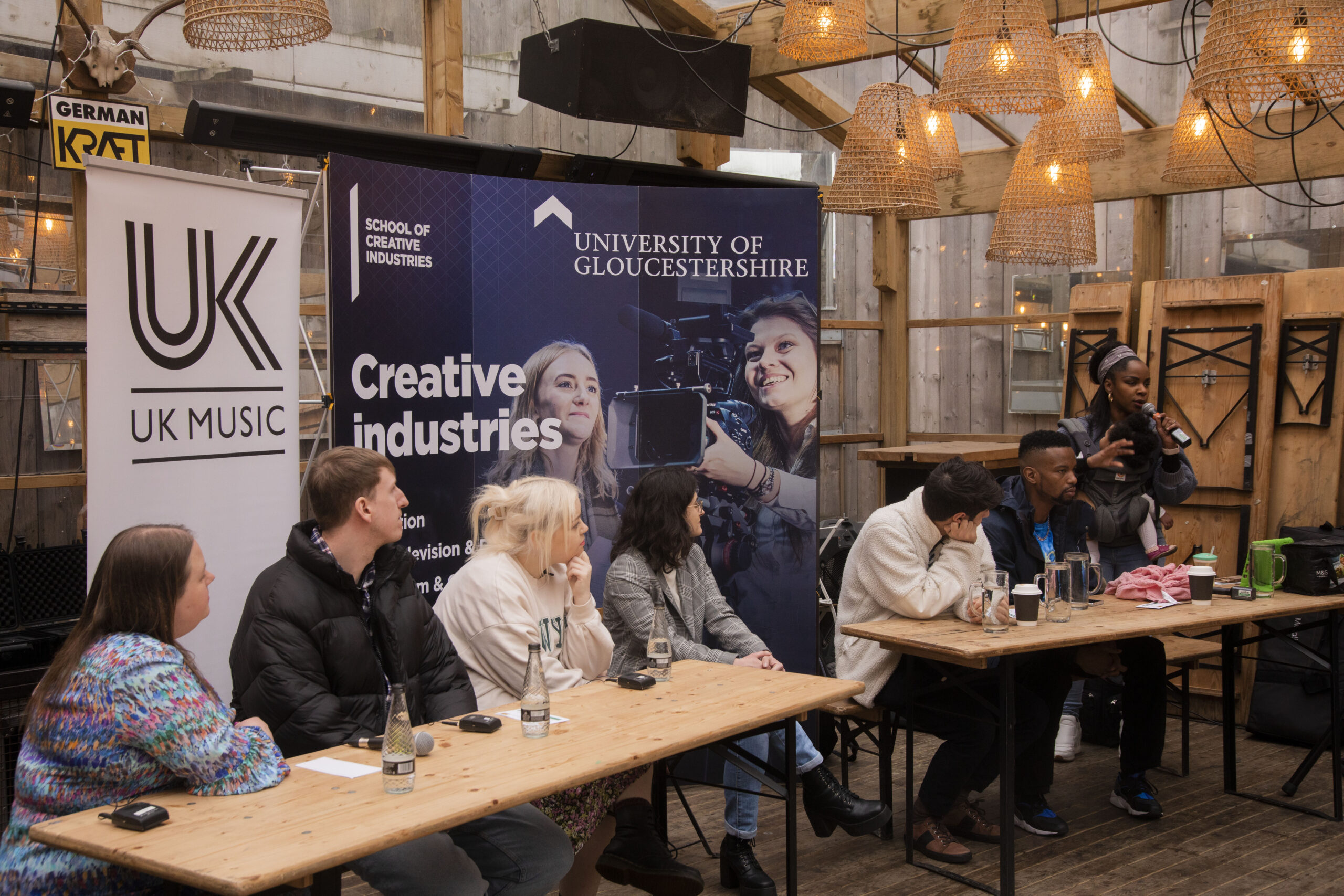Graduates sat at tables on the panel for Music and Sound networking event with UK Music.