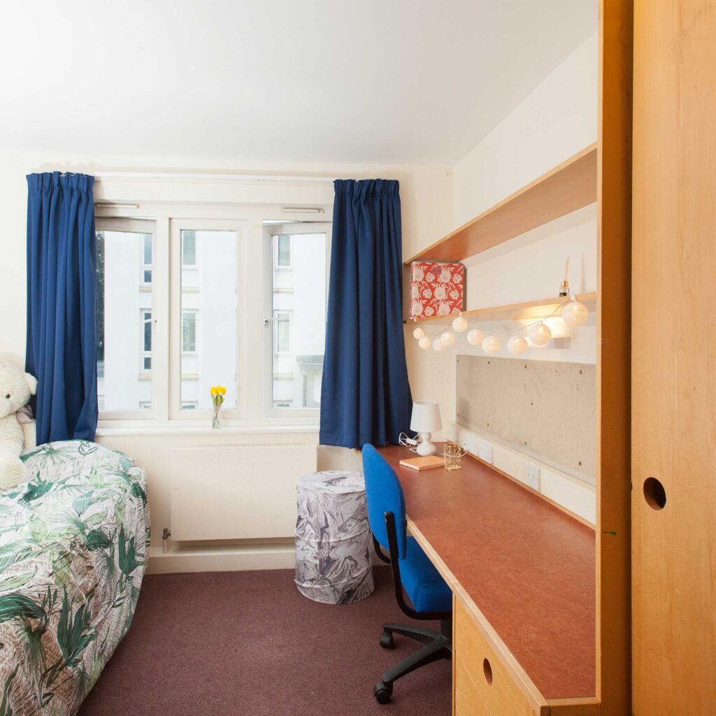 Room in Park Villas student accomodation at park campus with desk, chair, bed and wardrobe.