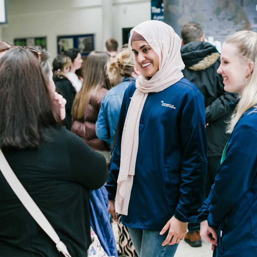Student ambassadors stood chatting at an event on campus