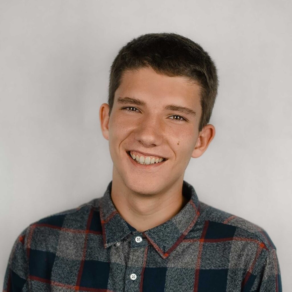 Head and shoulders photo of Michal smiling.