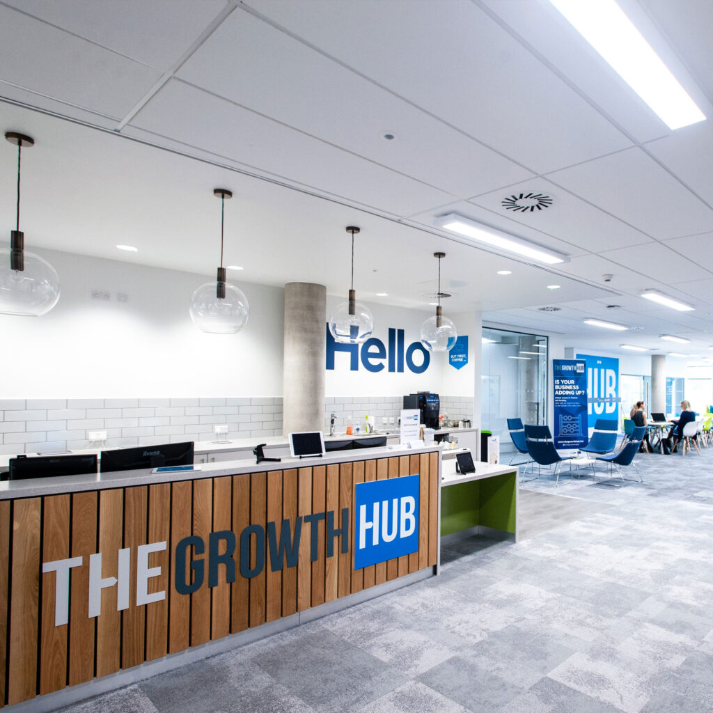 Interior of Gloucester Growth Hub showing welcome desk, tables and chairs