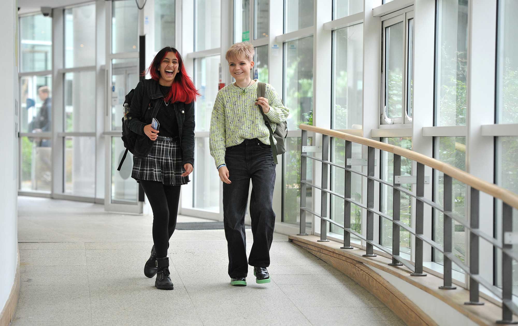 Two students walk along a corridor at Park campus.