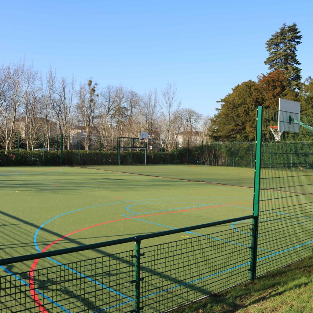 MUGA Pitch at Park with markings and basketball nets set up.