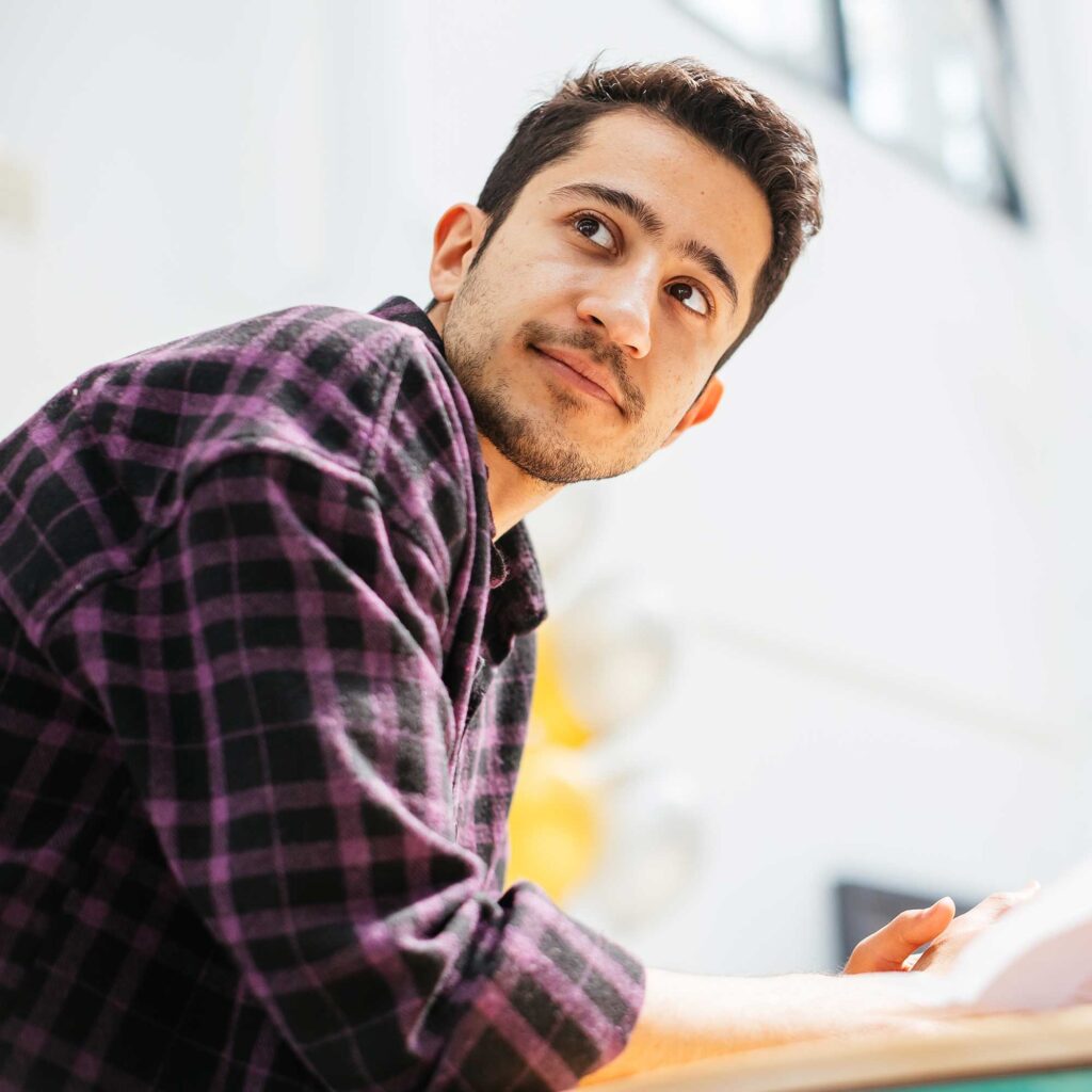 A male student looking into the distance