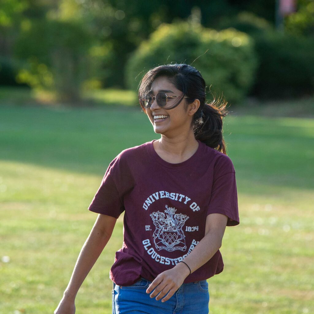 A student wearing a University of Gloucestershire t-shirt.