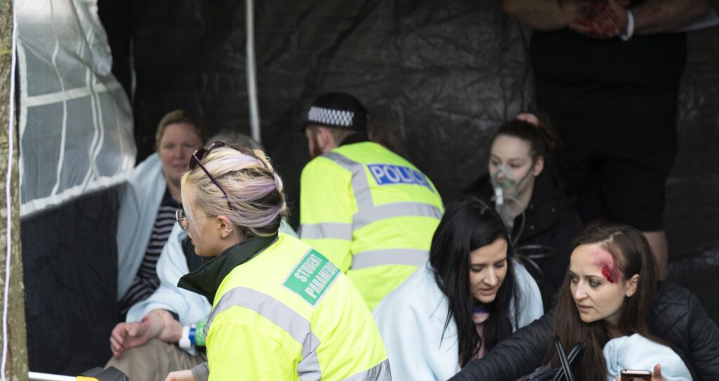 injured people waiting to be attended to in a tent