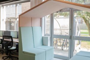Work spaces at FuturePark showing break-out areas, desks, chairs and computer screens.