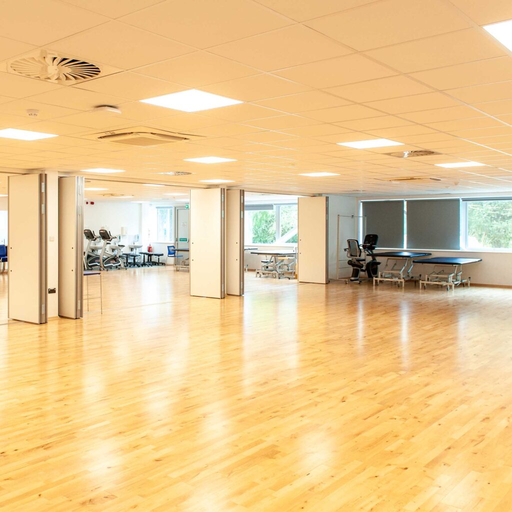 The rehab suite at Oxstalls Campus, with various beds and sports equipment set up.