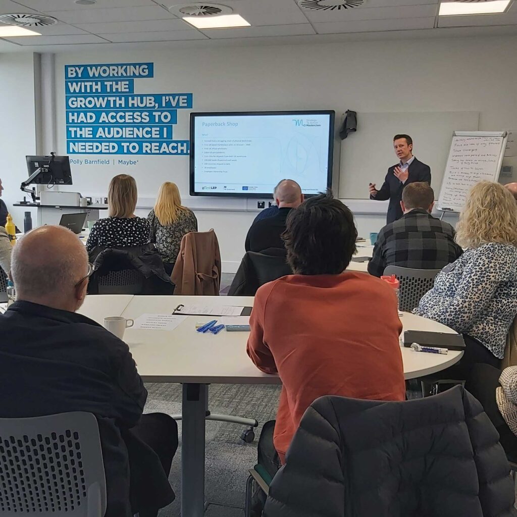 A man giving a presentation to a room of people.