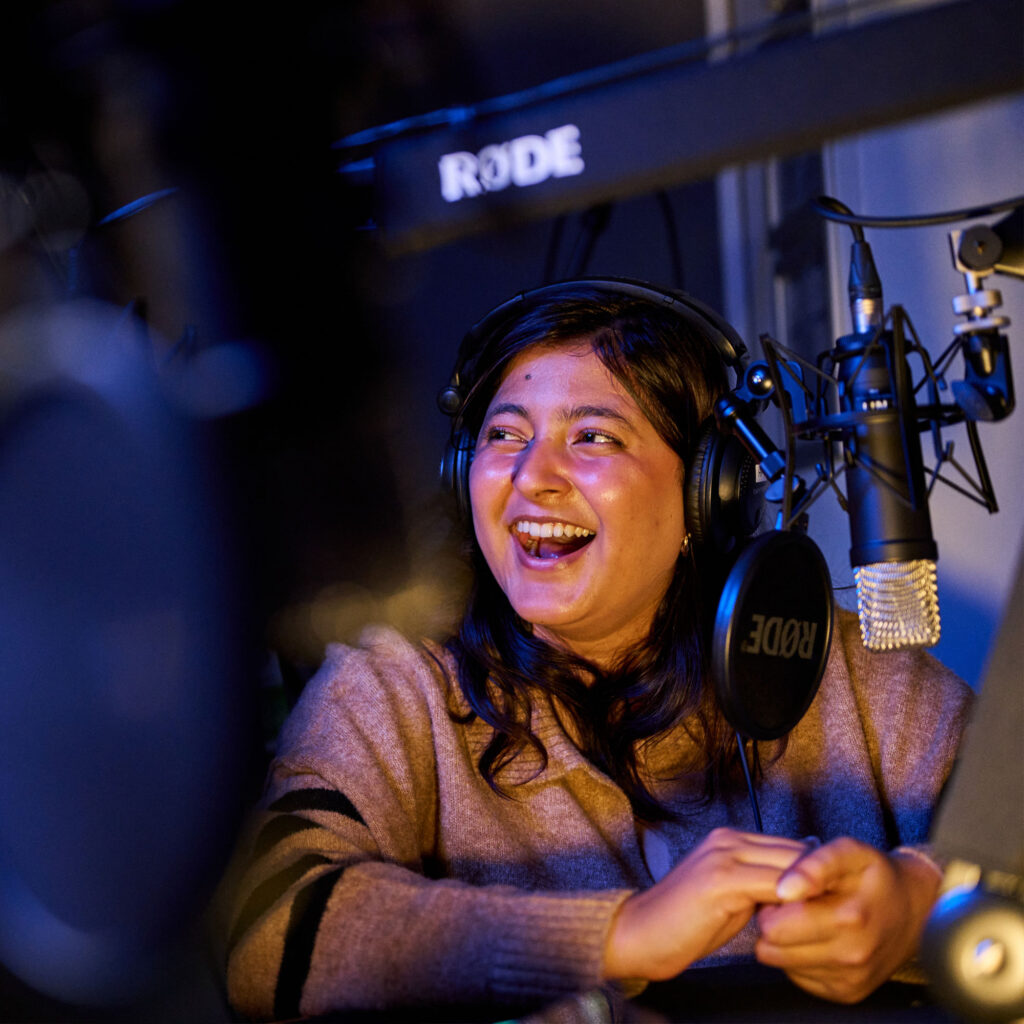 Student in recording studio wearing headphones