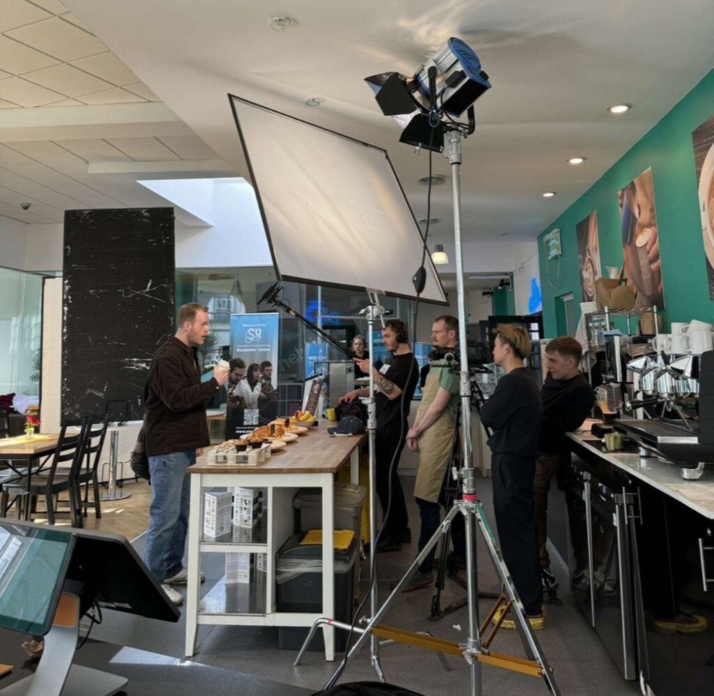 a scene being filmed for The Face featuring a crew with cameras