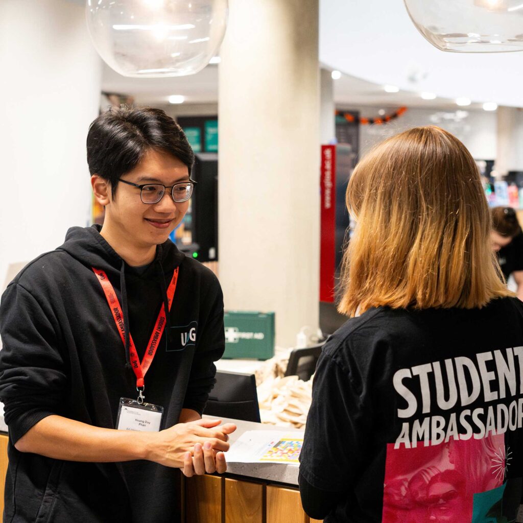 Two student ambassadors chatting at an Open Day.