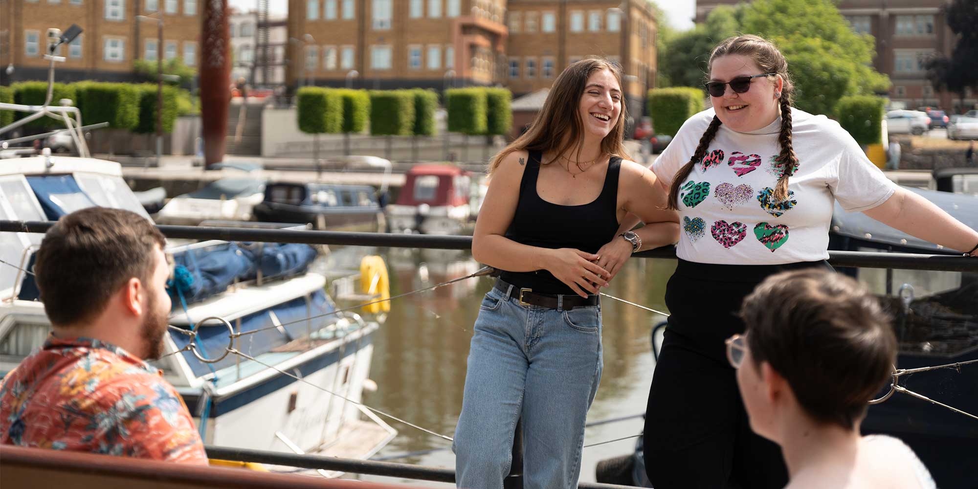 4 students laughing at the Gloucester Docks.