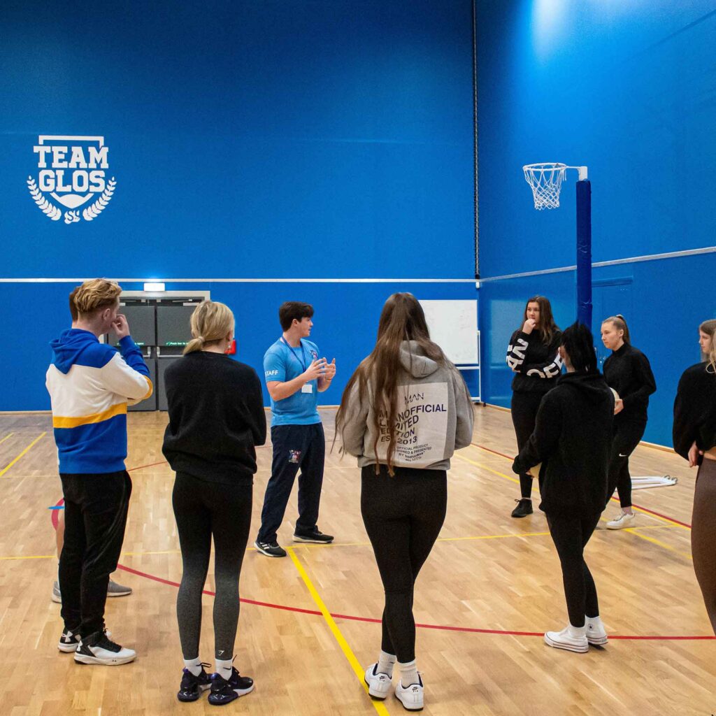 Students stood in the Oxstalls sports arena during a session.